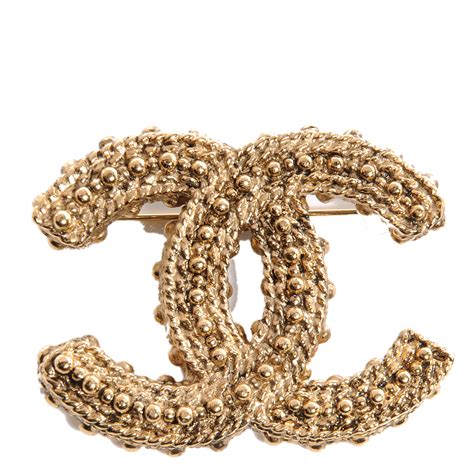 gold Chanel brooch